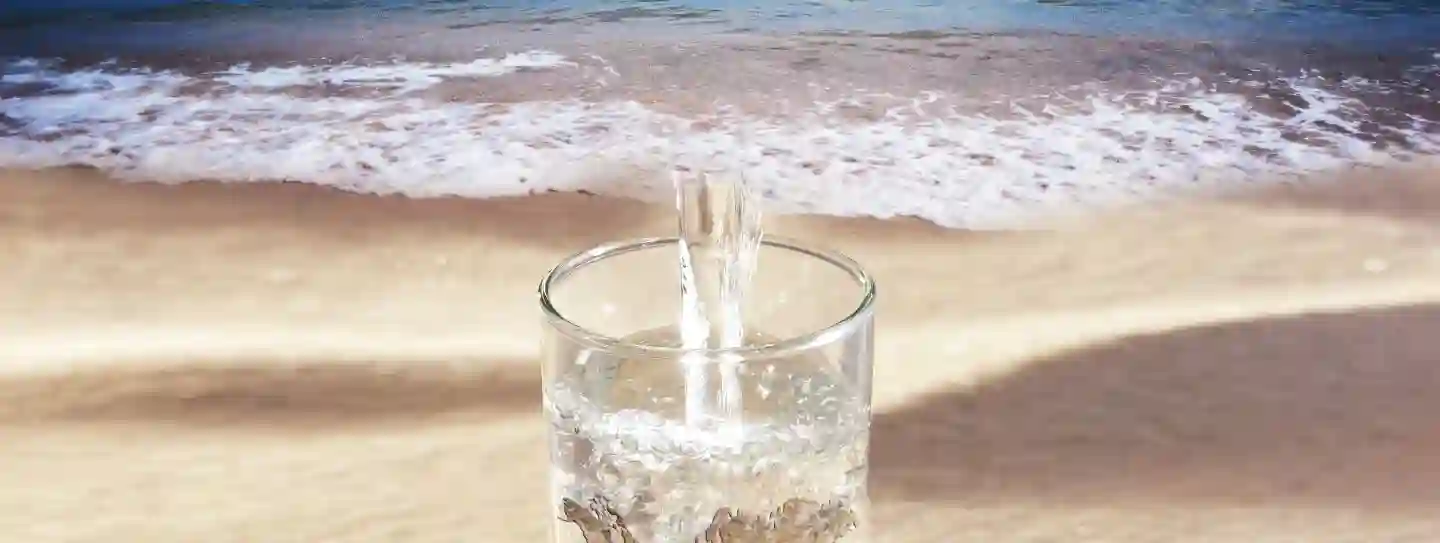 Vaso de agua en una playa