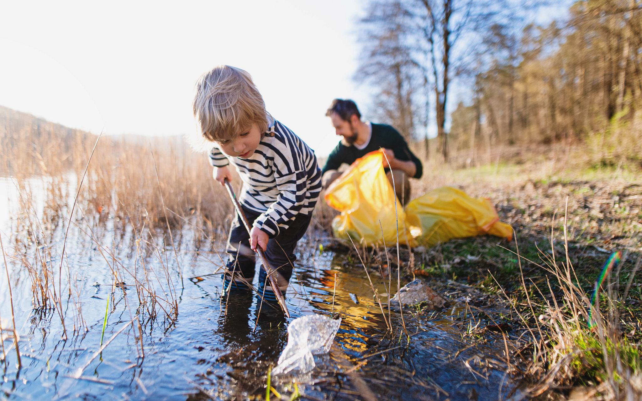 Man and child picking garbage image