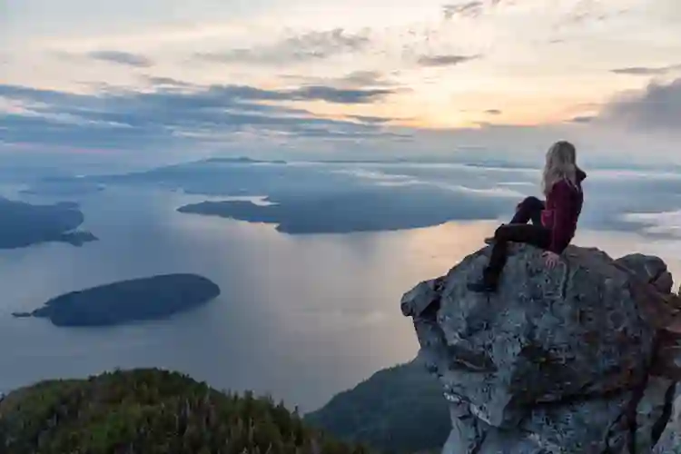 girl on cliff overlooking sea