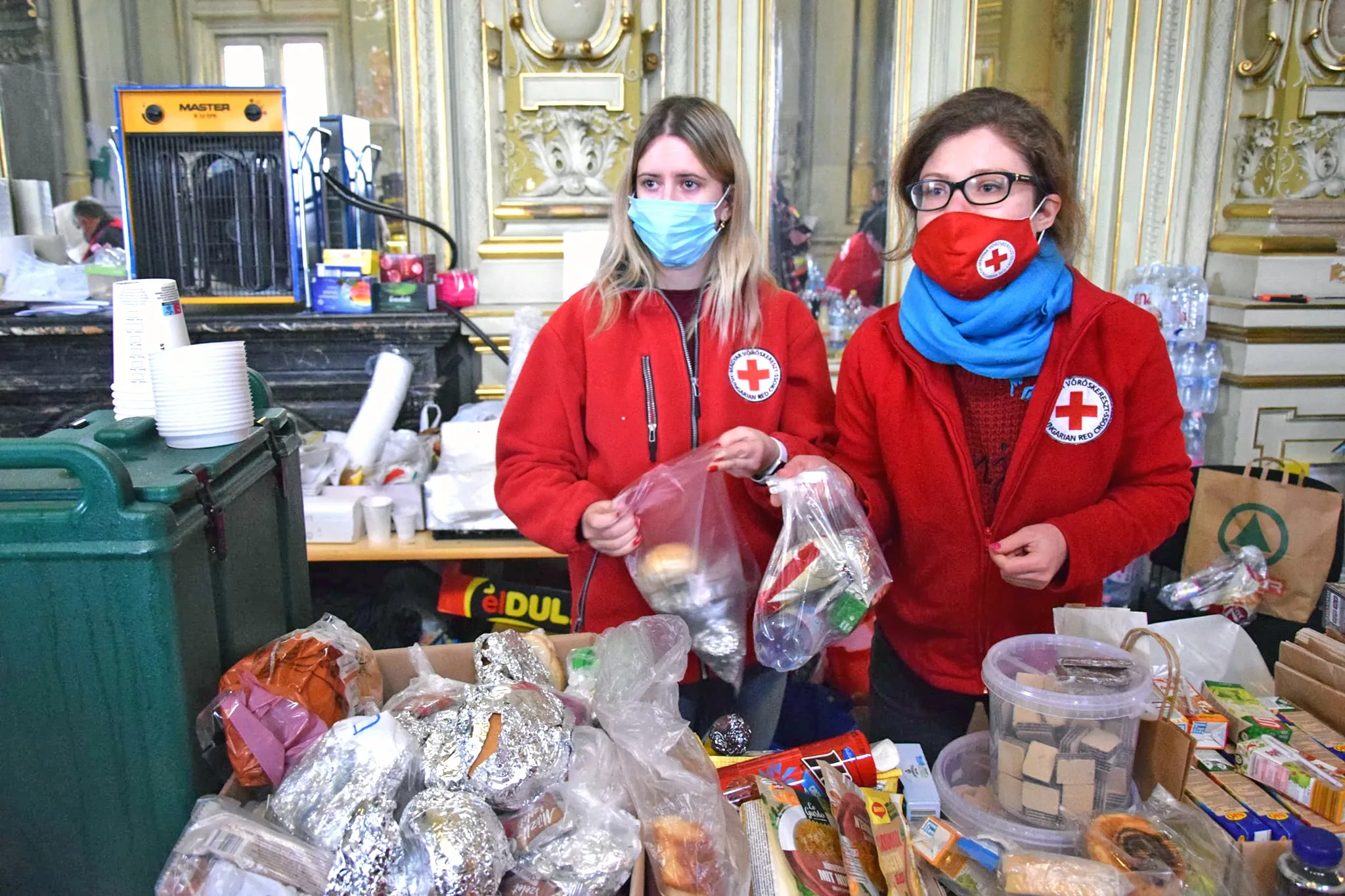 Hungarian Red Cross workers distributing bags of food