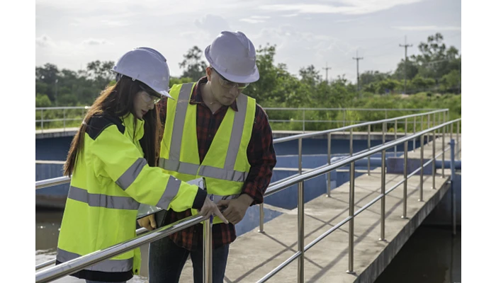 Water plant supervisors assessing equipment at a water recycling plant for reuse.