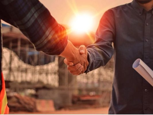 People shaking hands outside