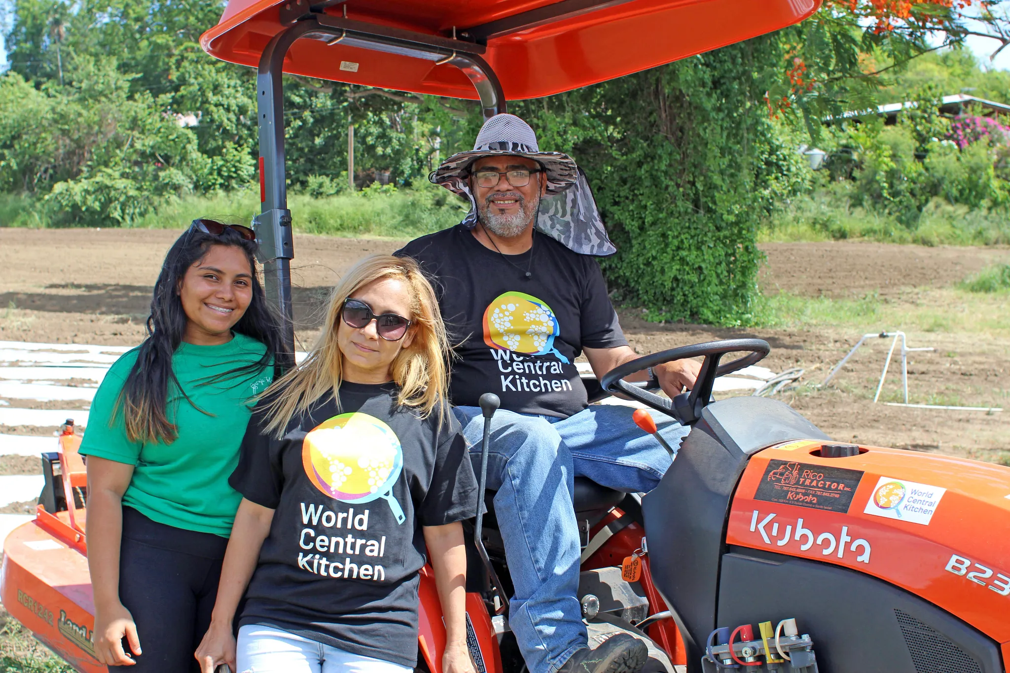 World Central Kitchen workers with a farm tractor