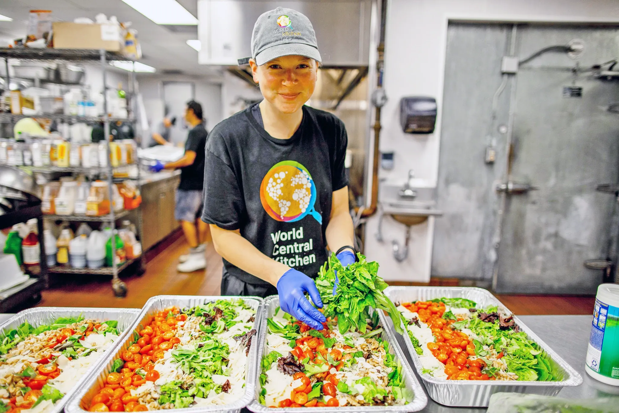 World Central Kitchen worker preparing salad